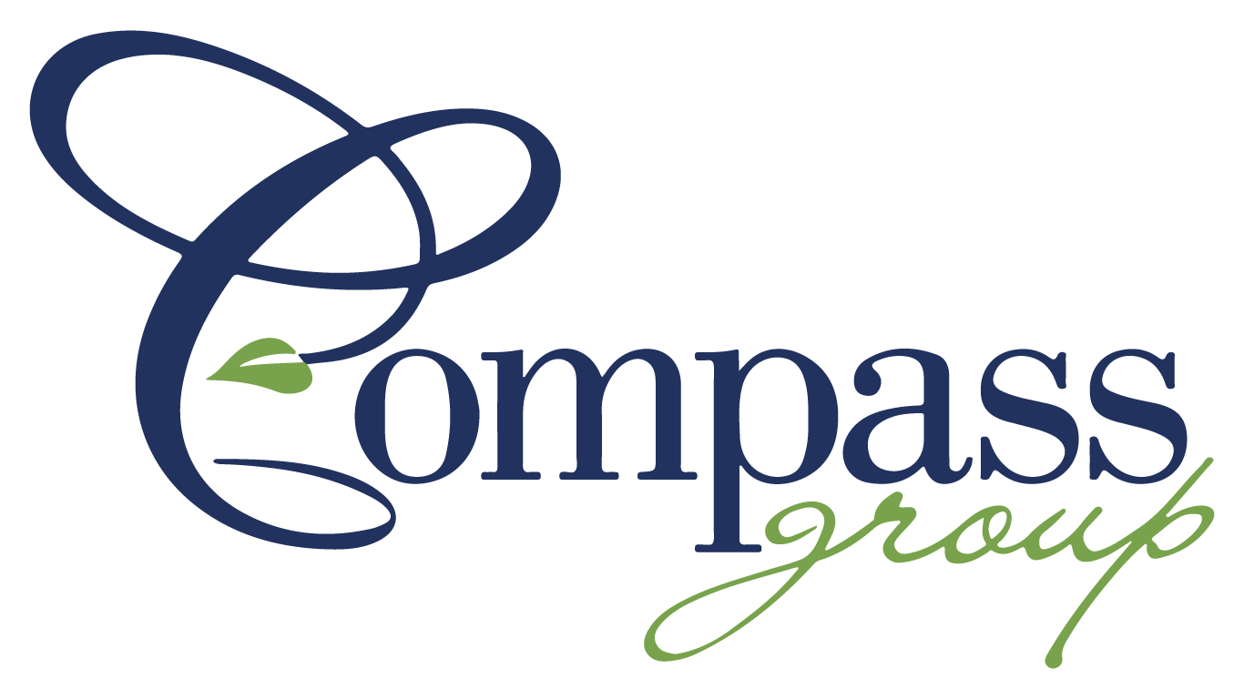 Logo of Compass Group with "Compass" in elegant blue script and a green leaf in the "C." "Group" appears in cursive green, all on an empty background.